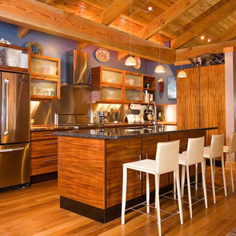 Modern kitchen with wooden cabinets and stainless steel appliances.